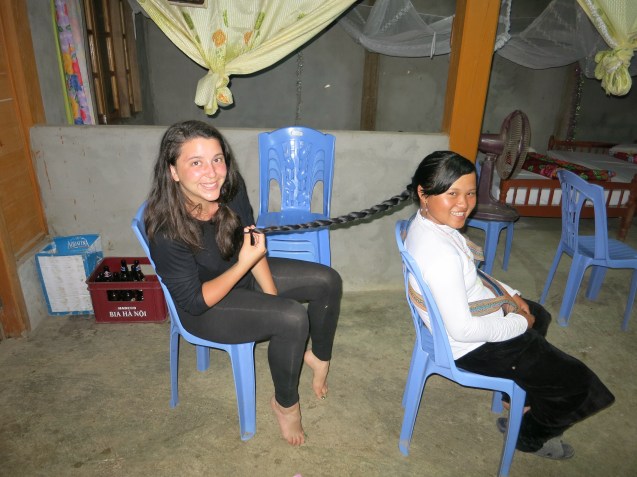 Giulia braiding Zaazaa's hair